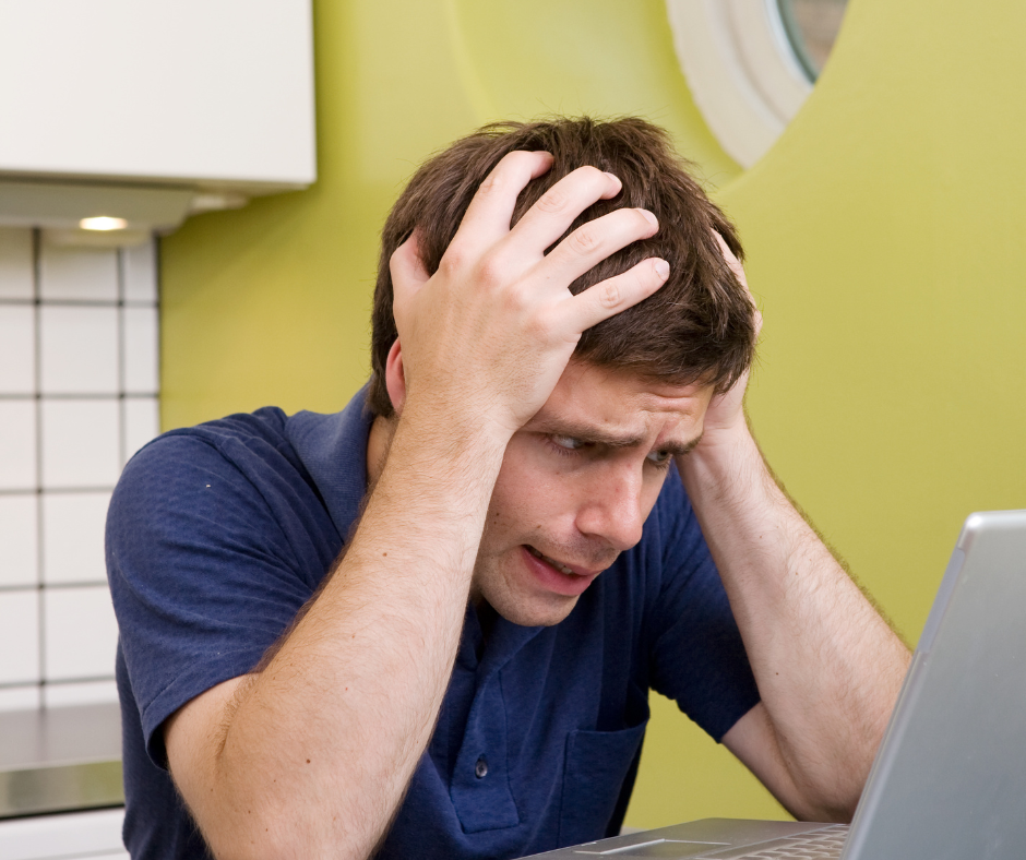 Frustrated young man at laptop