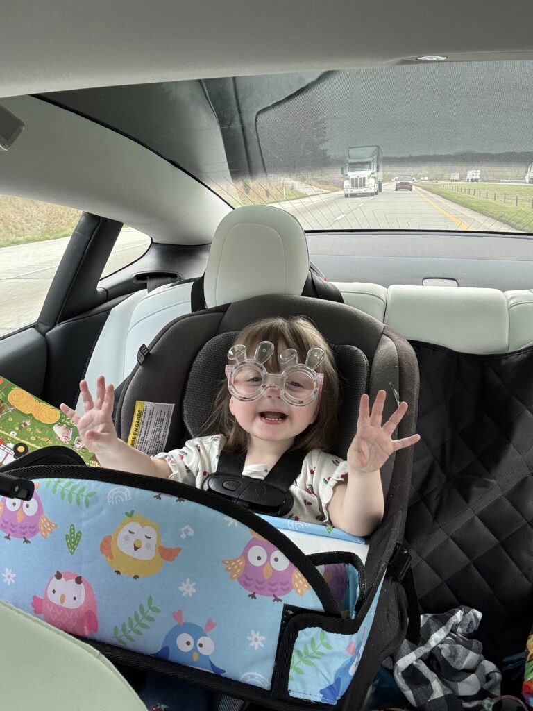Young girl in a car on a roadtrip.
